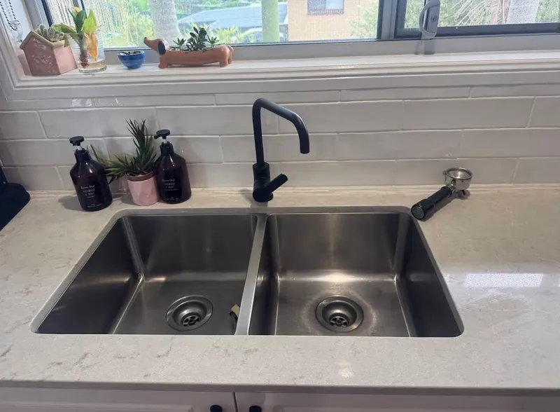 Sanitized oven, rangehood, and sink fixtures inspected during bond cleaning Kingston