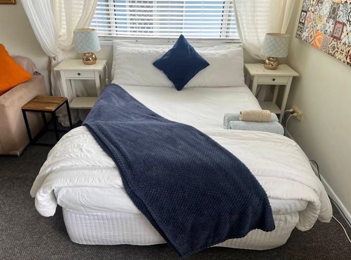 Meticulously arranged designer bedroom with pristine linens and styling